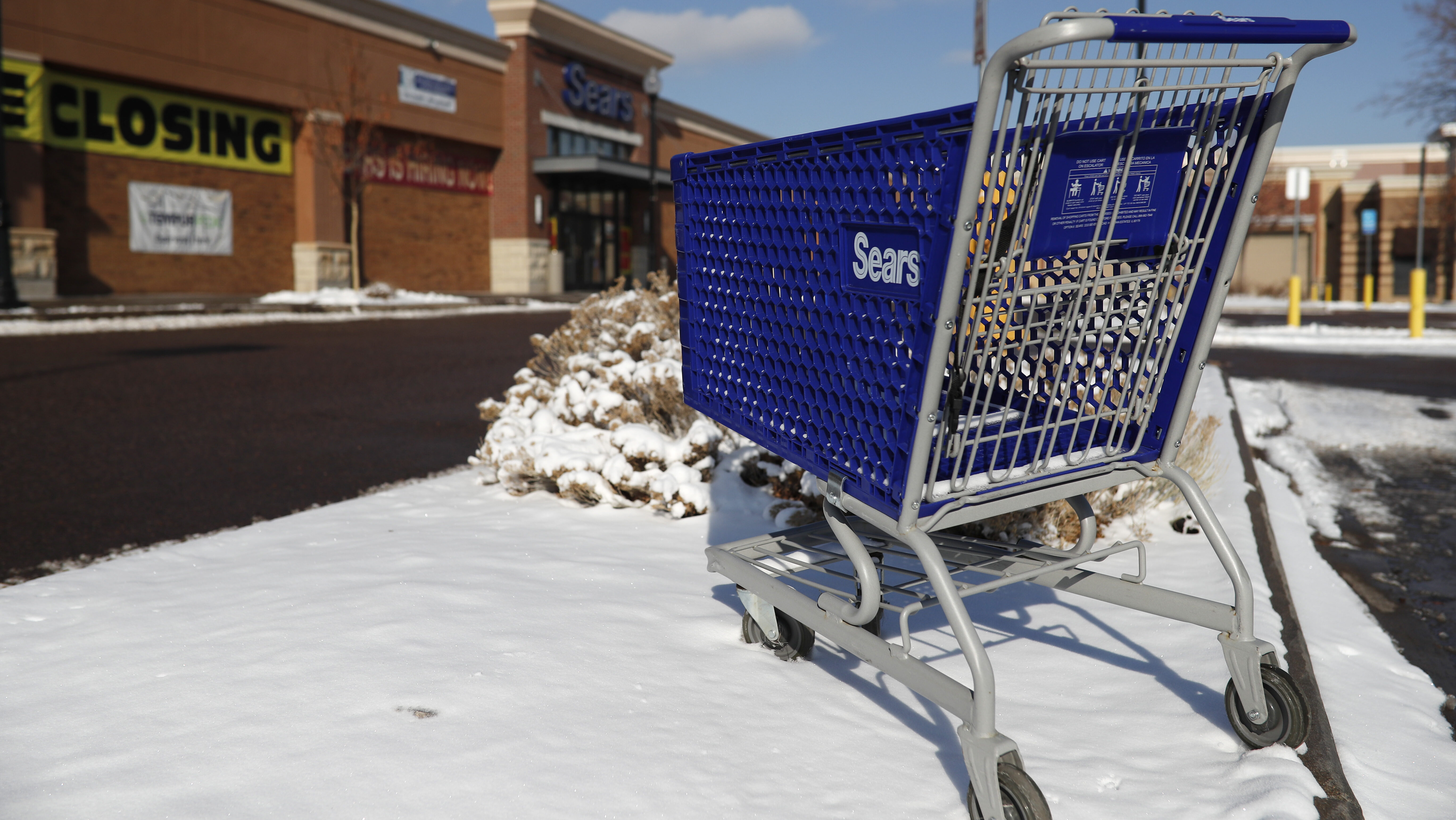 In this 2019 file photo, an empty shopping cart sits outside a Sears store in the Streets of Southg...