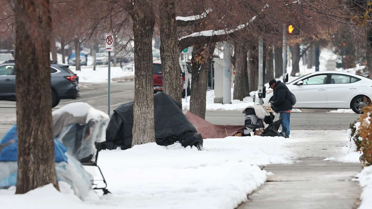 FILE: A man stands at a homeless tent camp in Salt Lake City on Dec. 20, 2022. Utah County releases...