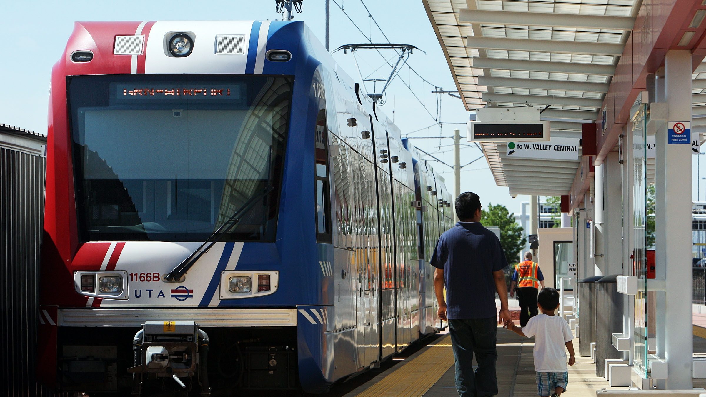 FILE -- Passengers board a TRAX train at Salt Lake City International Airport....