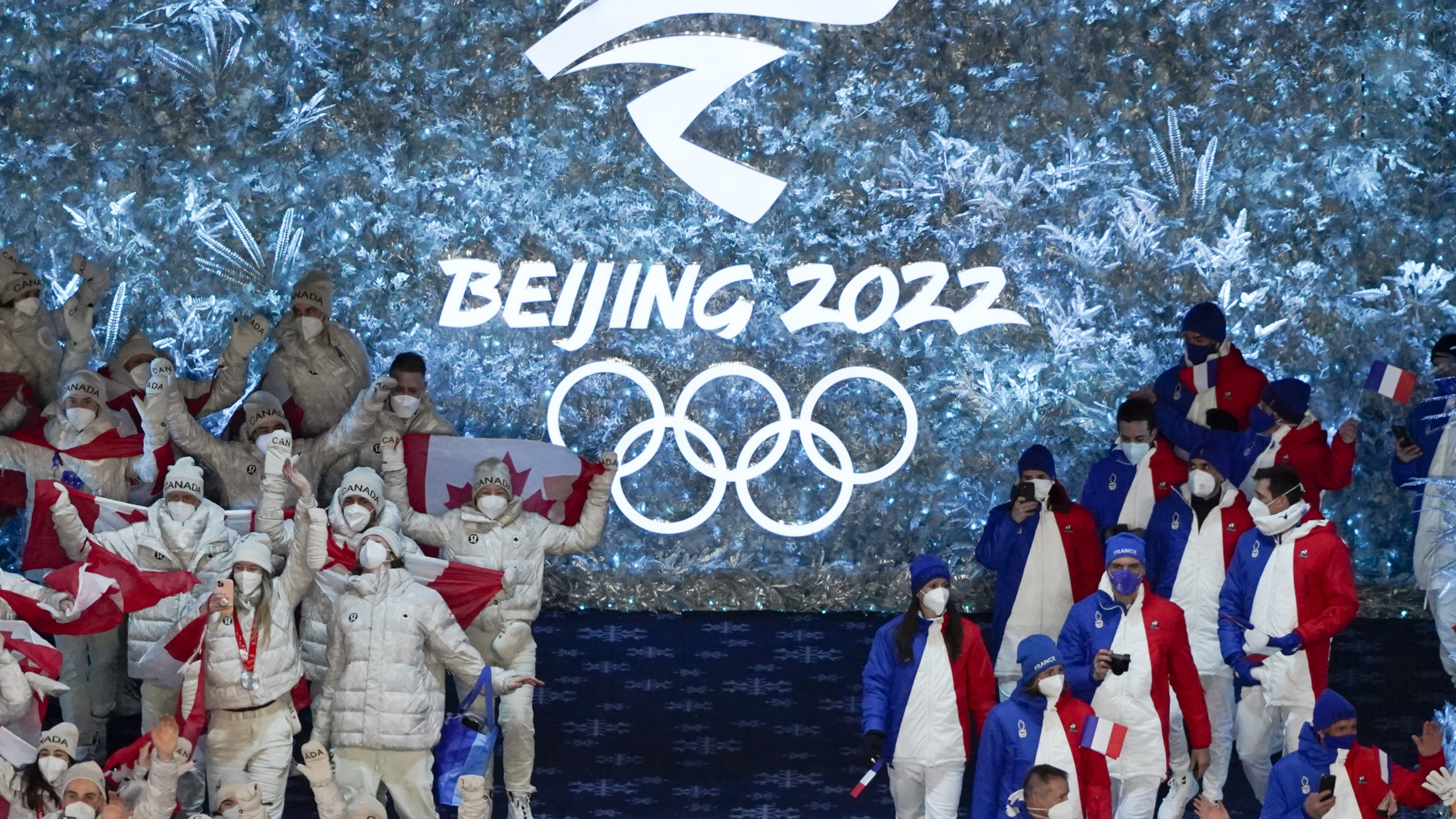 Canada, left, and France arrive at the closing ceremony of the 2022 Winter Olympics, Sunday, Feb. 2...