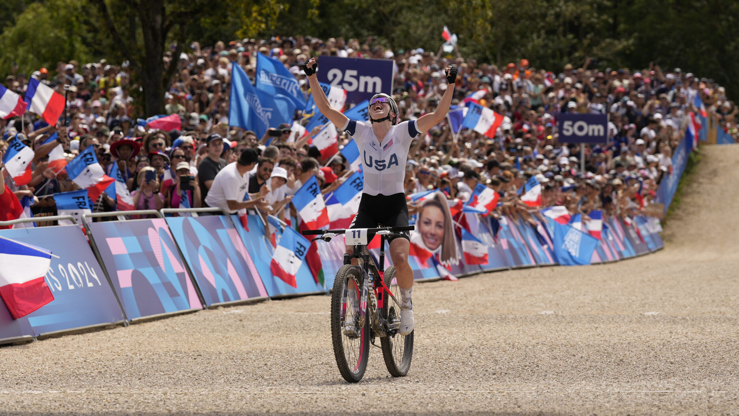 Haley Batten, of United States, celebrates her second place in the women's mountain bike cycling ev...