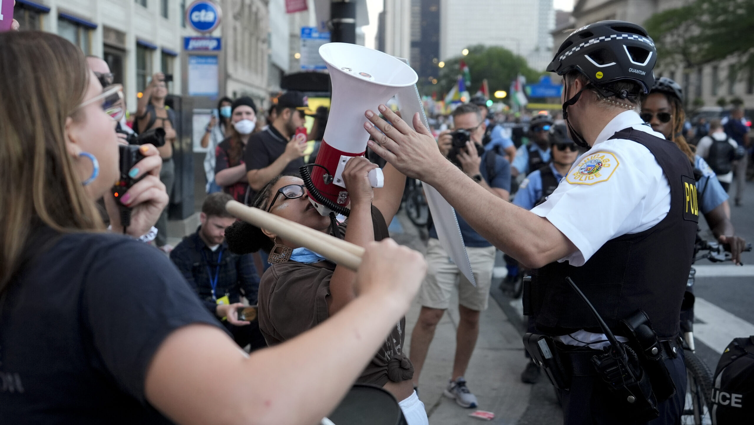 A police officer directs a protester during a march prior to the start of the Democratic National C...