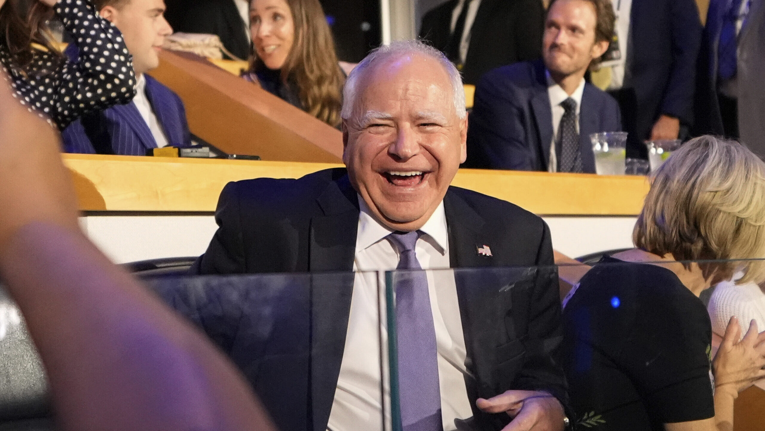 Democratic vice presidential nominee Minnesota Gov. Tim Walz laughs as he arrives at the DNC Monday...