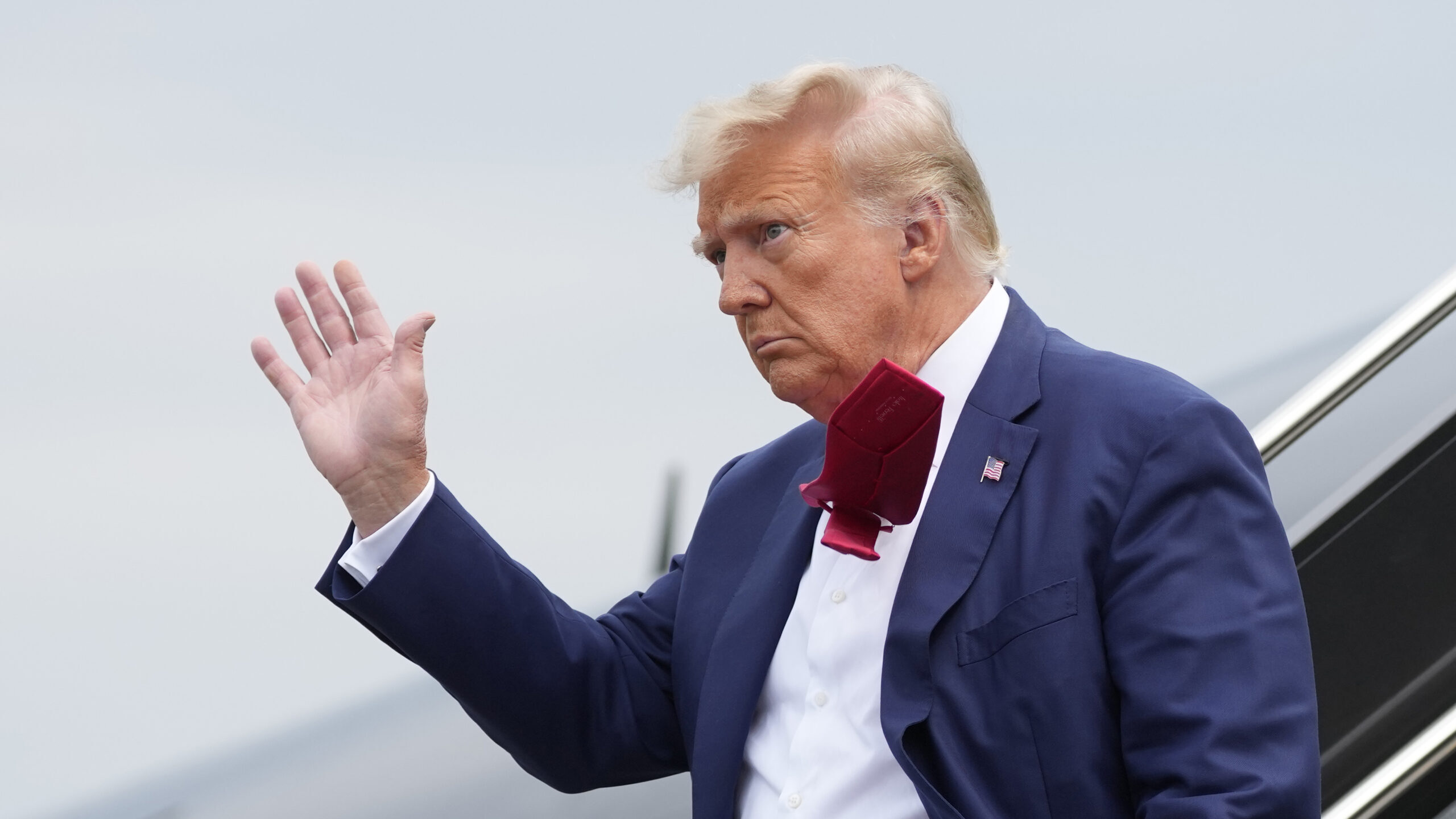 FILE - Former President Donald Trump waves as he steps off his plane at Ronald Reagan Washington Na...