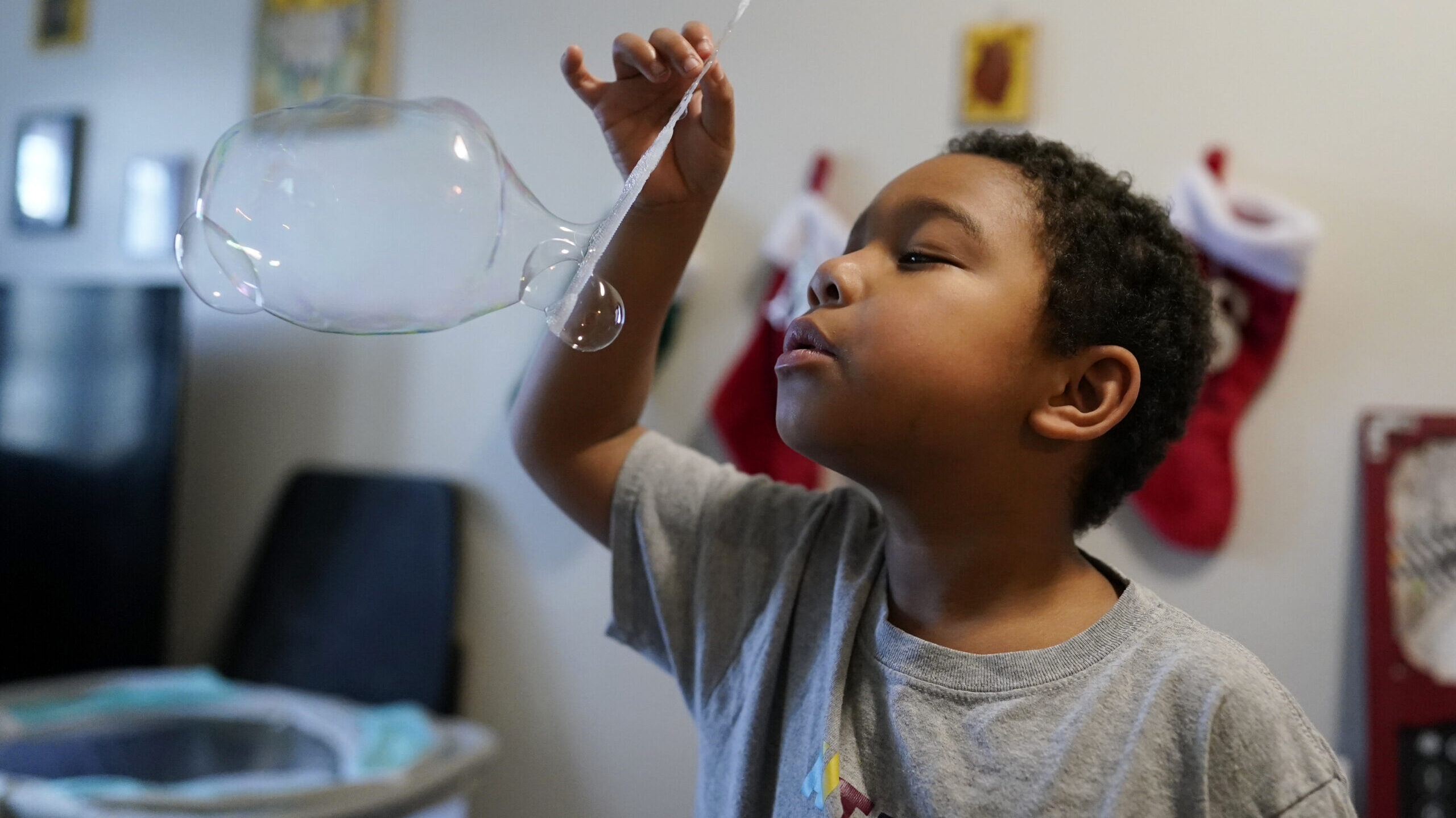 a child plays with a bubble, utah medicaid changing for kids...