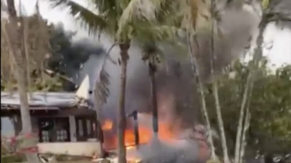 This frame grab from video shows fire coming from a plane that crashed by a home in Vinhedo, Sao Pa...