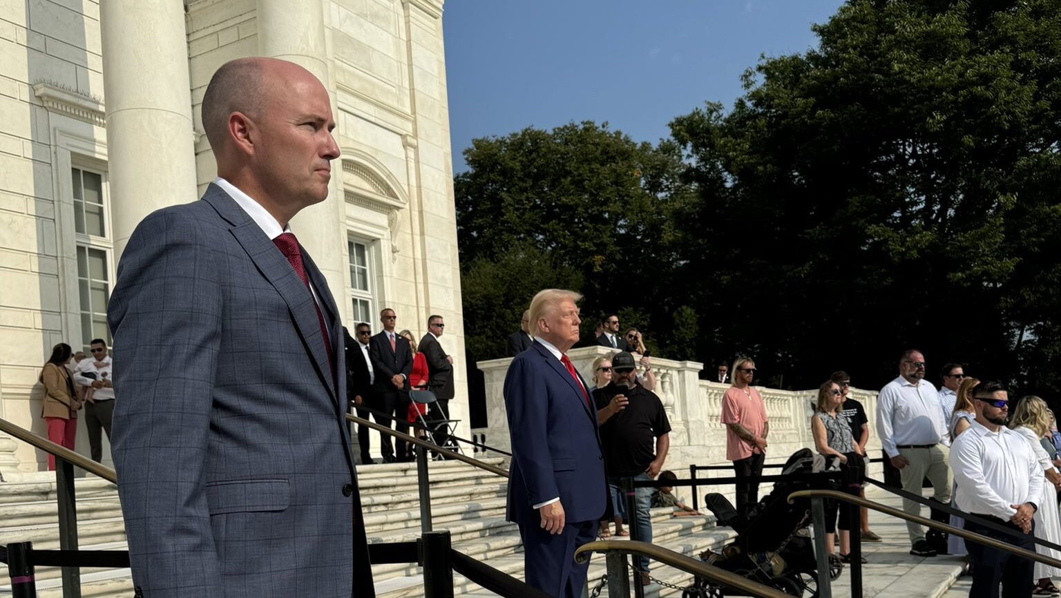 Utah Governor Spencer Cox and former President Donald Trump stand at the Tomb of the Unknown Soldie...