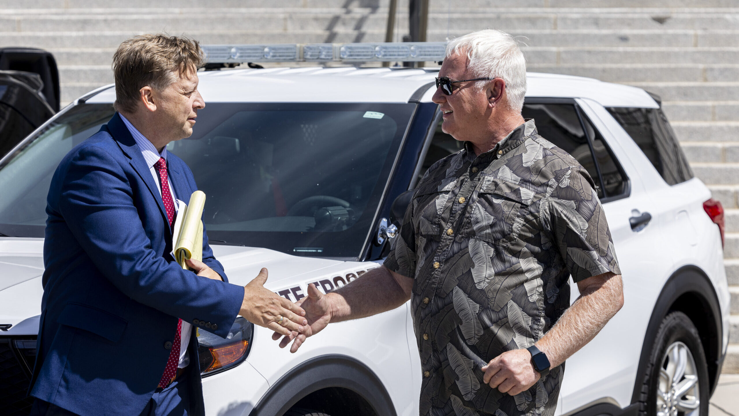 Peter Salm, a family member of a fatal road rage victim, shakes hands with Sen. Todd Weiler, R-Wood...