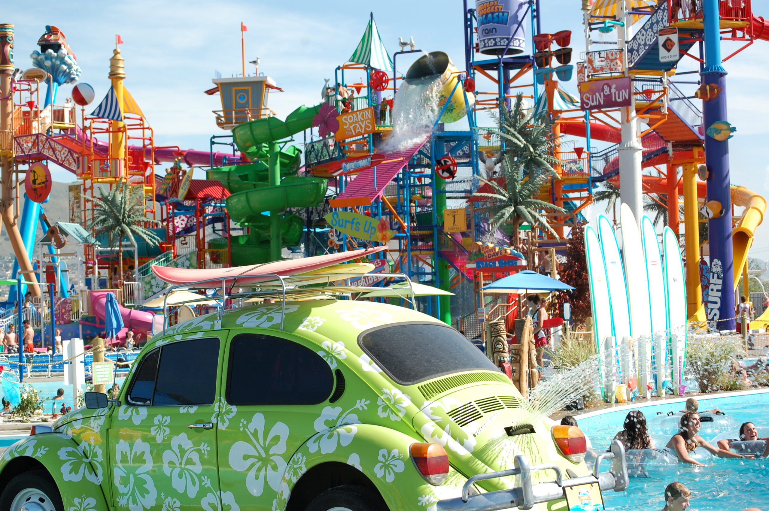 Water park with a vintage VW bug in front with a surfboard on top...