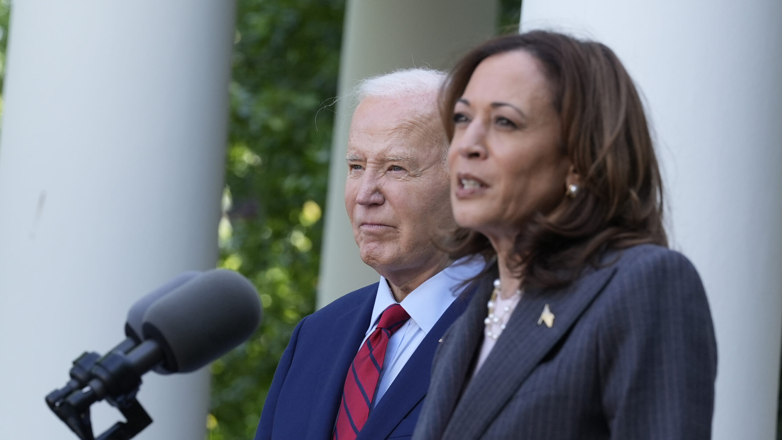 FILE - President Joe Biden listens as Vice President Kamala Harris speaks in the Rose Garden of the...