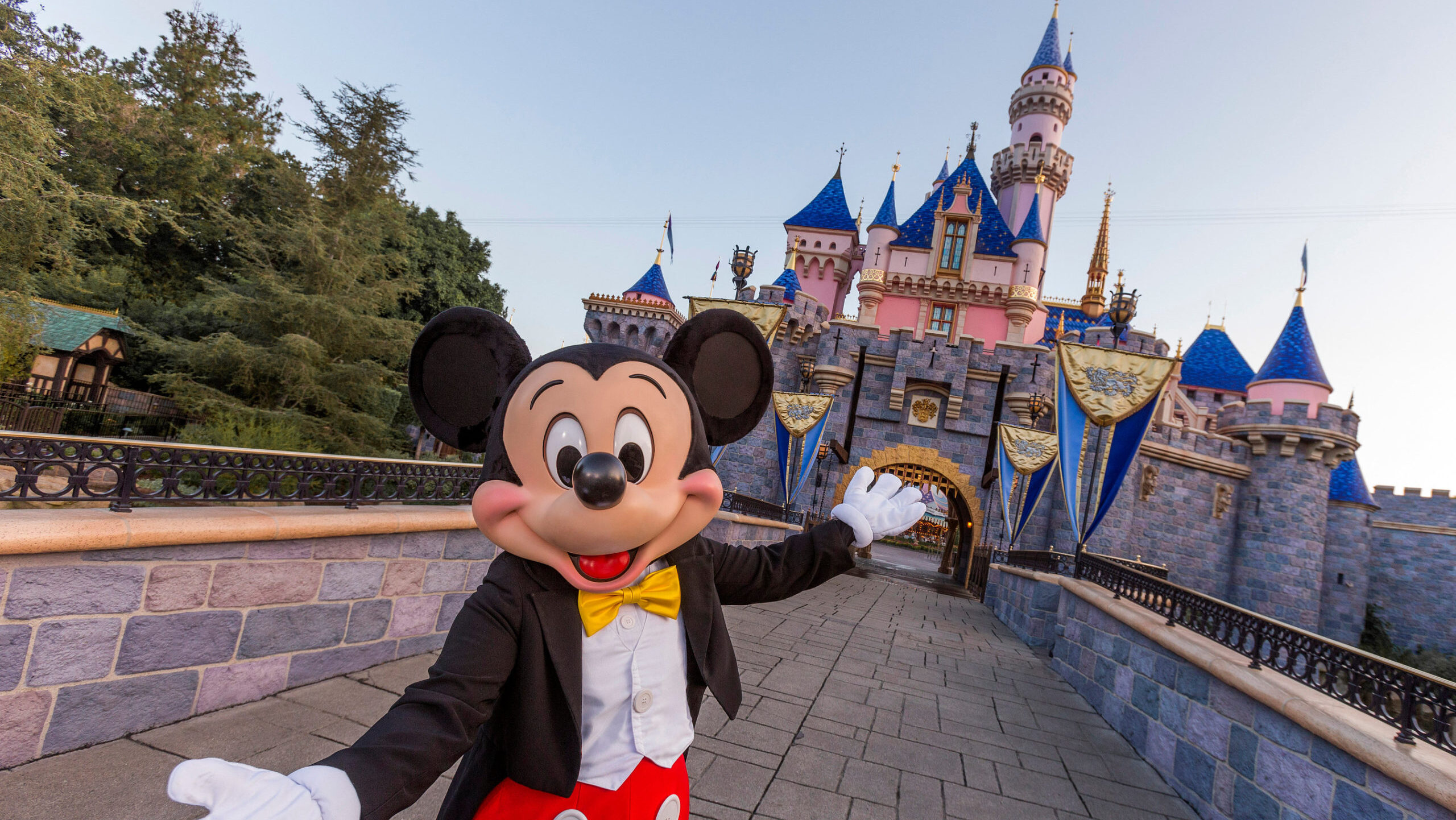 Mickey Mouse poses in front of Sleeping Beauty Castle at Disneyland Park on August 27, 2019 in Anah...