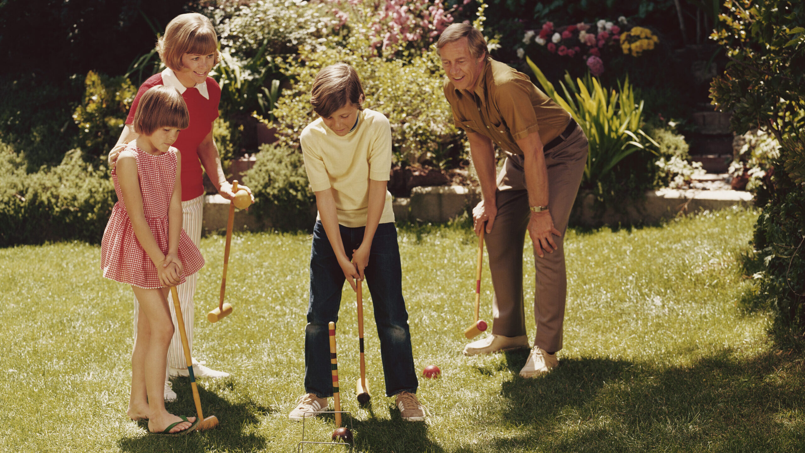 Two children playing croquet with their parents, circa 1975. (Fox Photos/Hulton Archive/Getty Image...