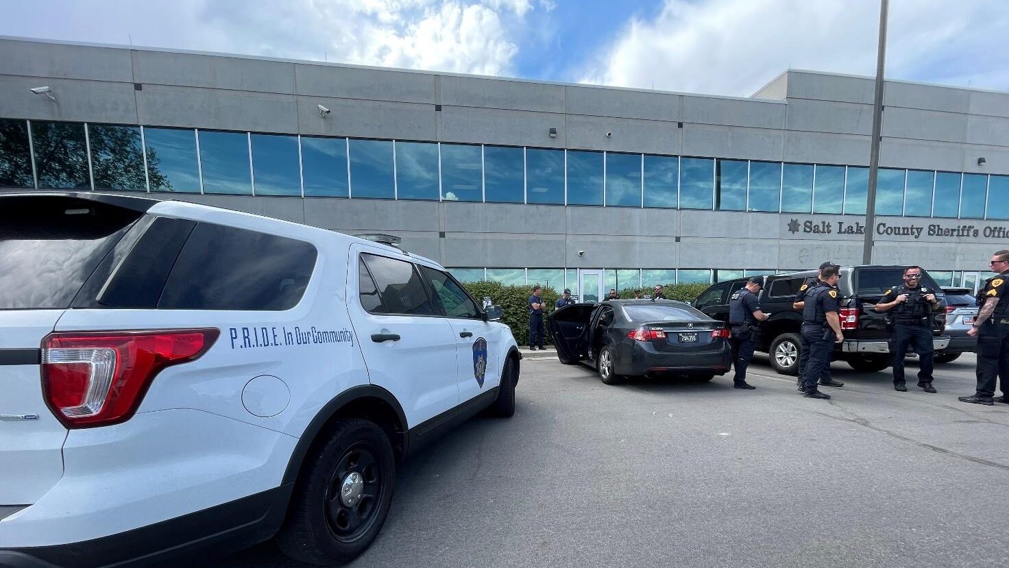 Photo: Salt Lake City Police officers stand next to a stolen car parked in front of the Salt Lake C...