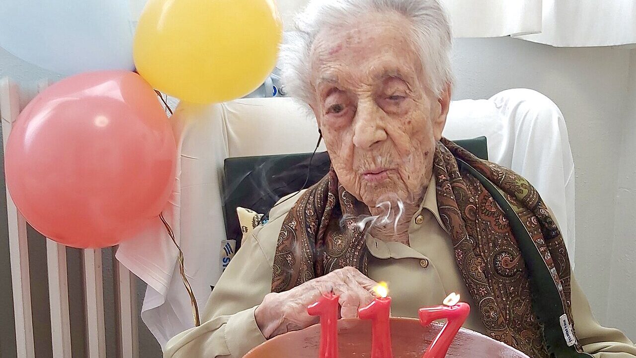 Maria Branyas blows out the candles on a cake celebrating her 117th birthday. Branyas was considere...