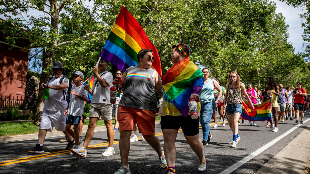 Heidi Thomas, left, and Meggane Vasquez, right, look at each other during the Rainbow March and Ral...