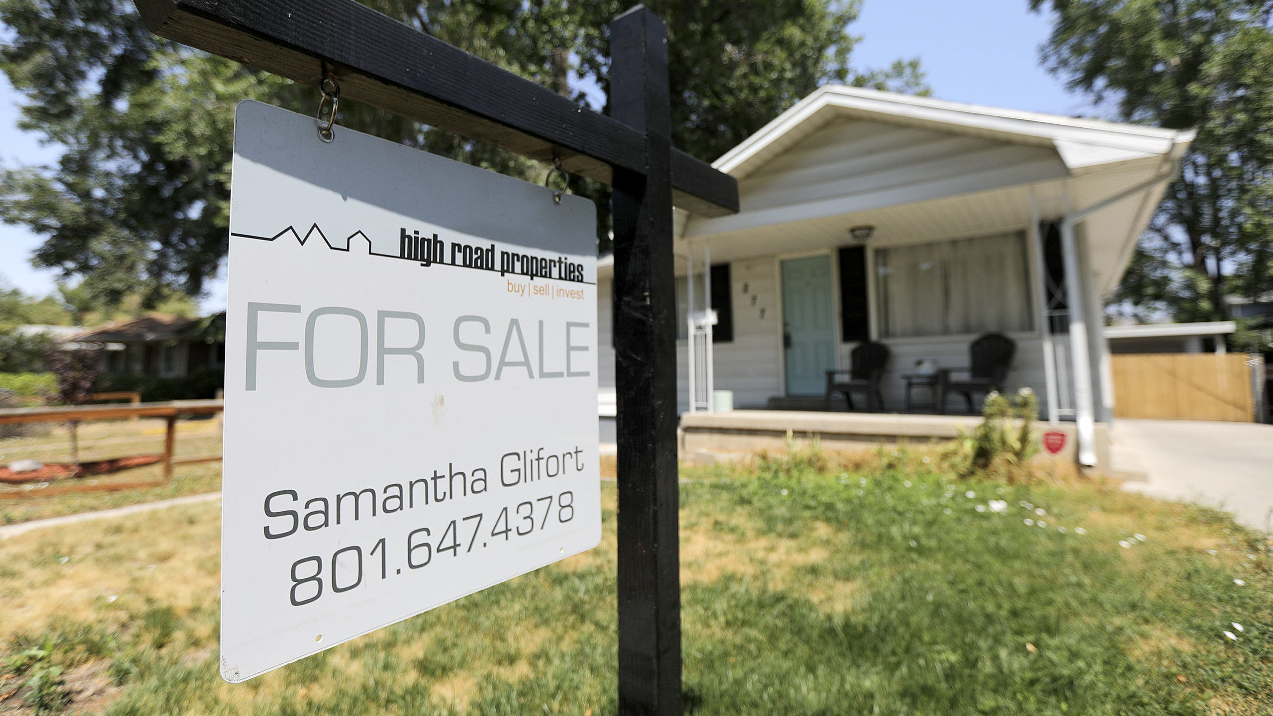 for sale sign in front of home...