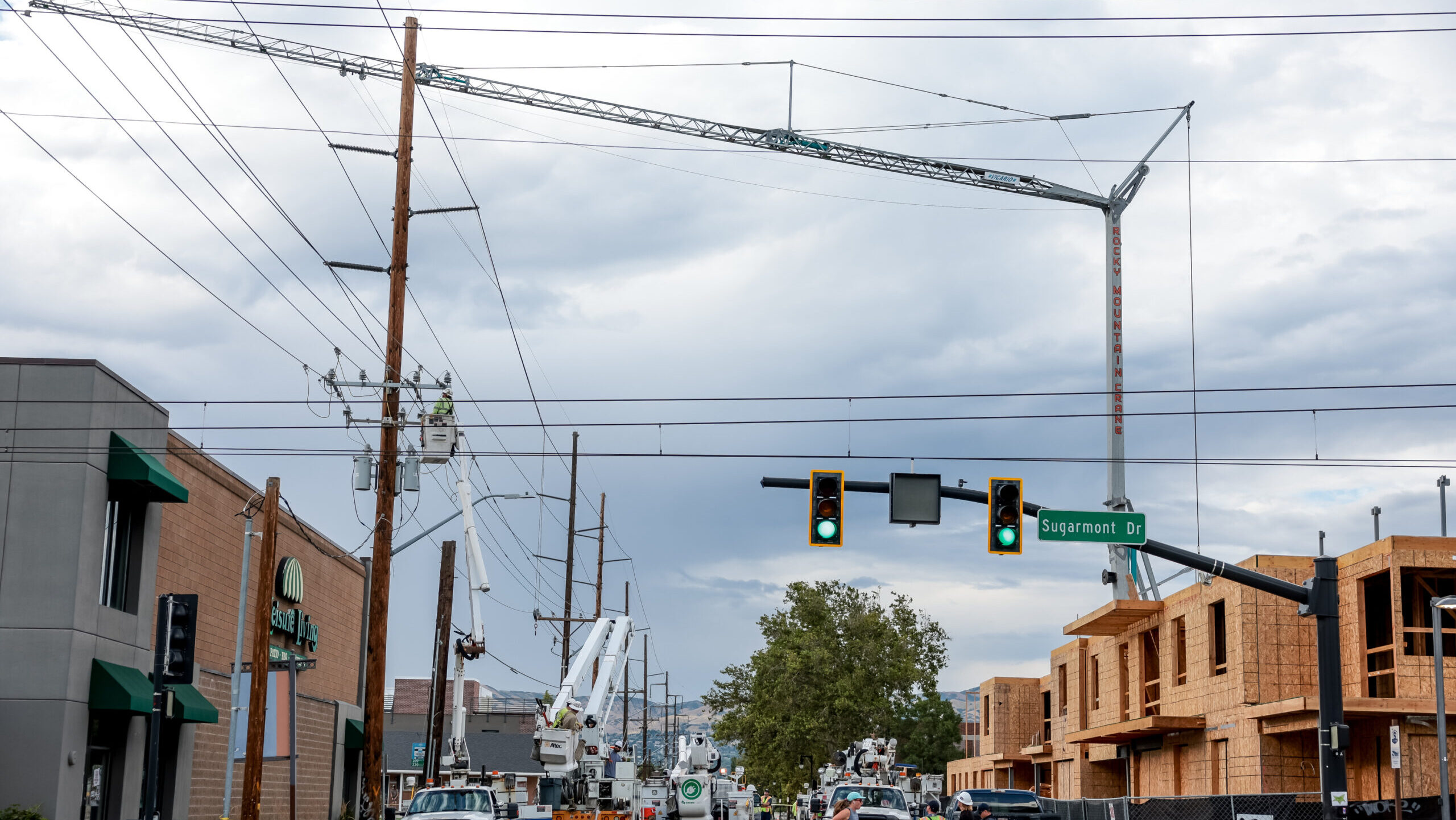 Rocky Mountain Power and emergency crews respond after a construction crane hit power lines on 900 ...