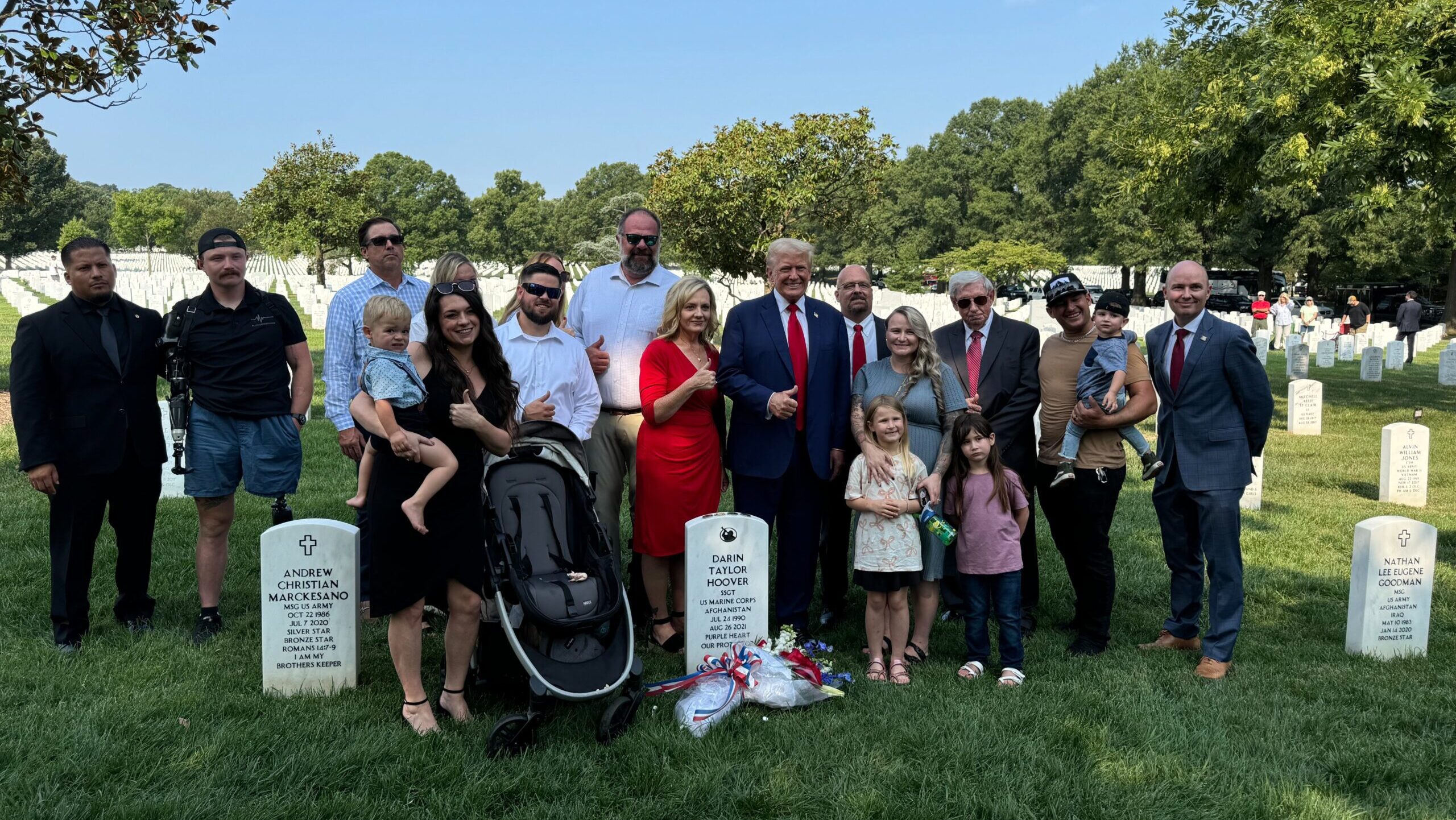 Former President Donald Trump and Governor Spencer Cox pose with the family of a deceased servicema...