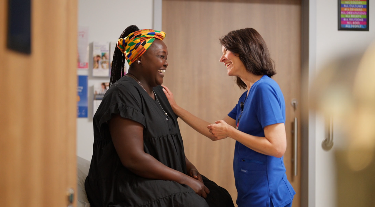 a doctor putting her hand on the chest of her patient...